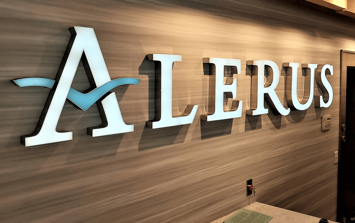 Alerus Financial Excelsior MN interior illuminated channel letters on wood grain wall