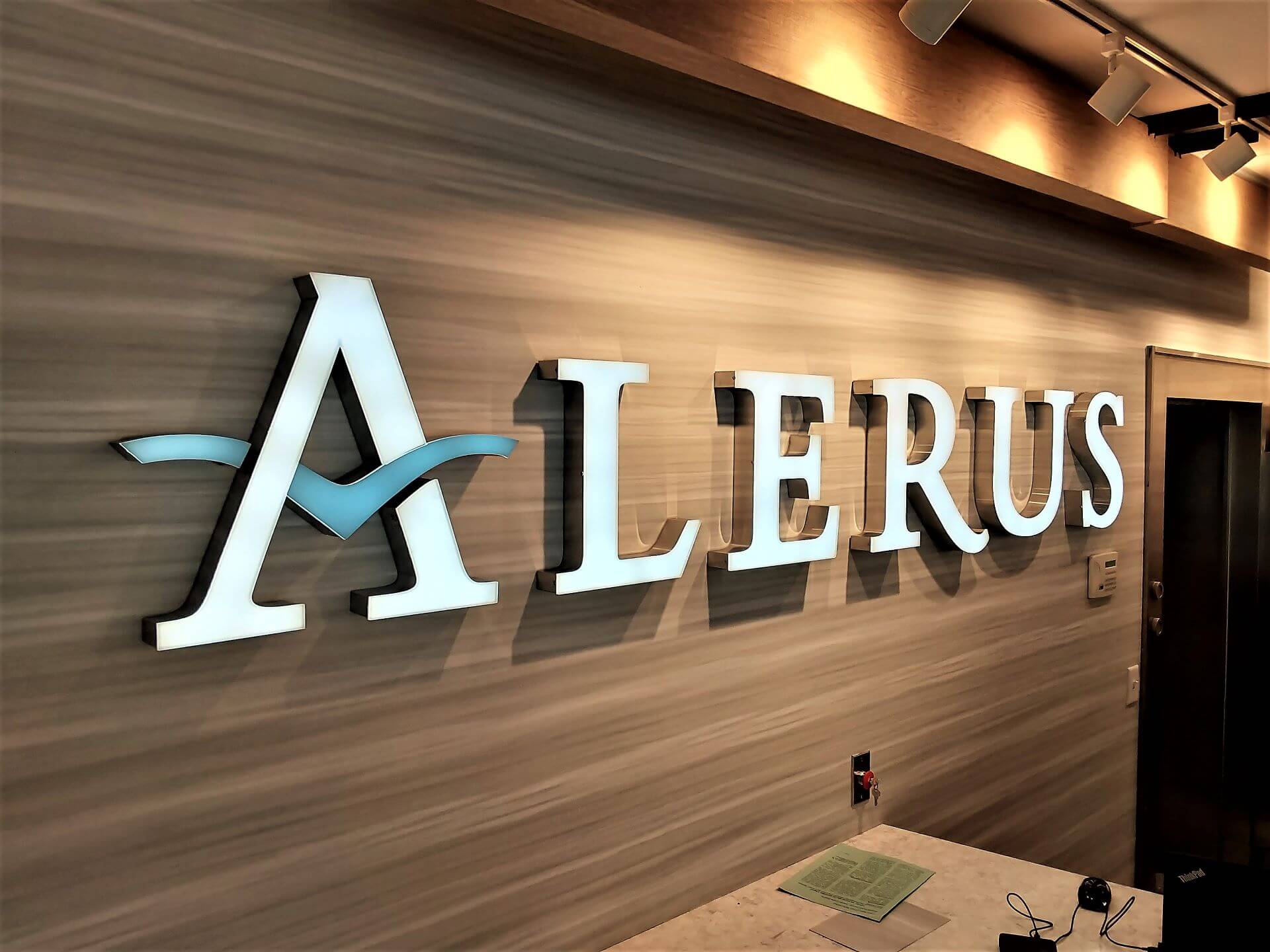 Alerus Financial Excelsior Custom Channel Letters Chrome Edges Installed on Wood Wall