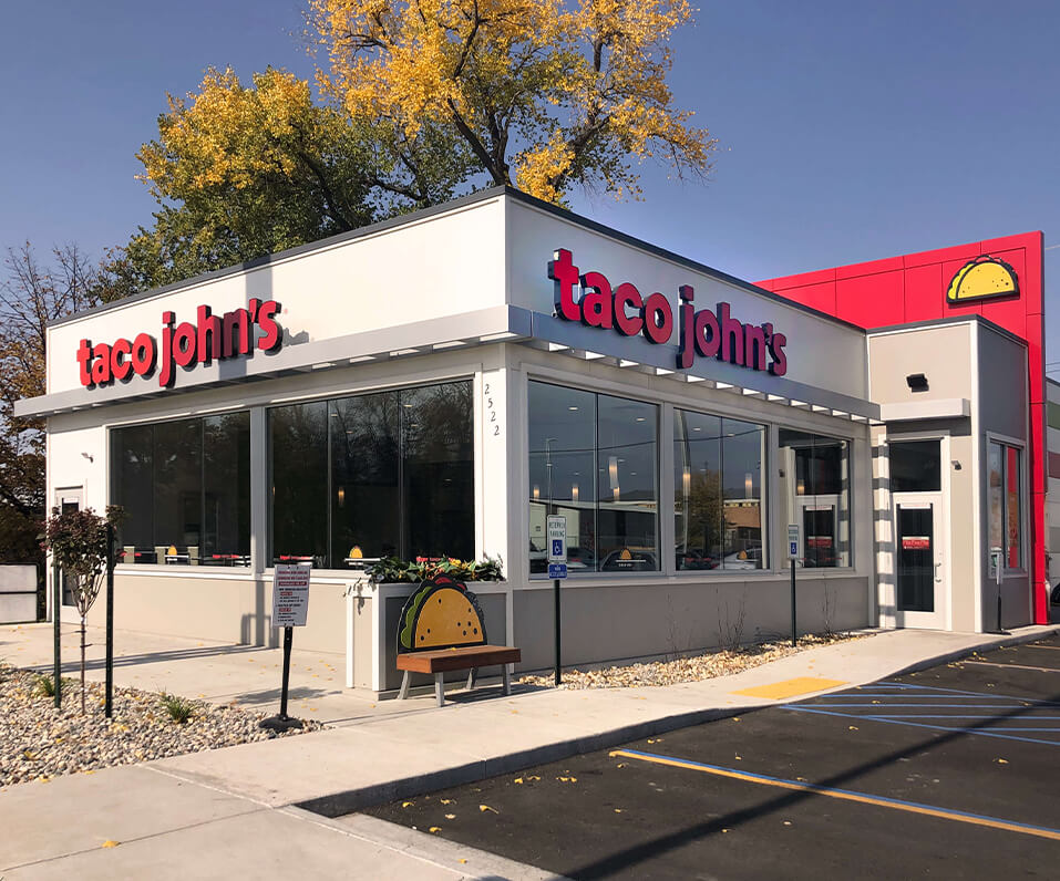 Taco Johns new branding on storefront grand forks nd showcasing channel letters printed custom bench and taco wall cabinet
