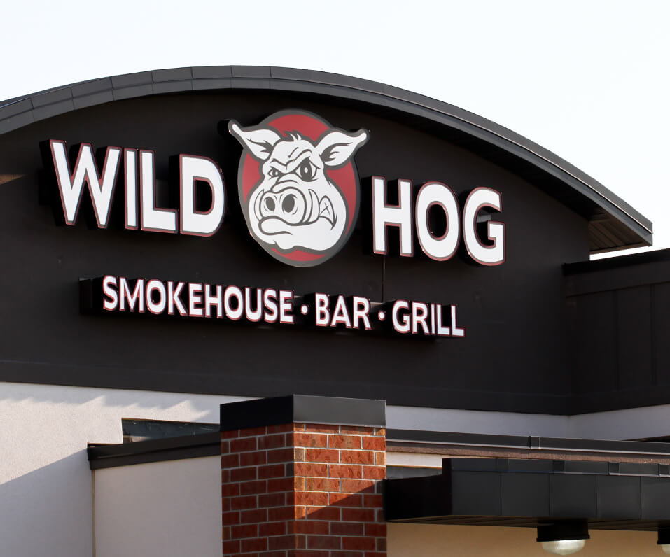 Wild Hot Smokehouse bar and grill channel letters on building front with custom logo cabinet Grand Forks ND